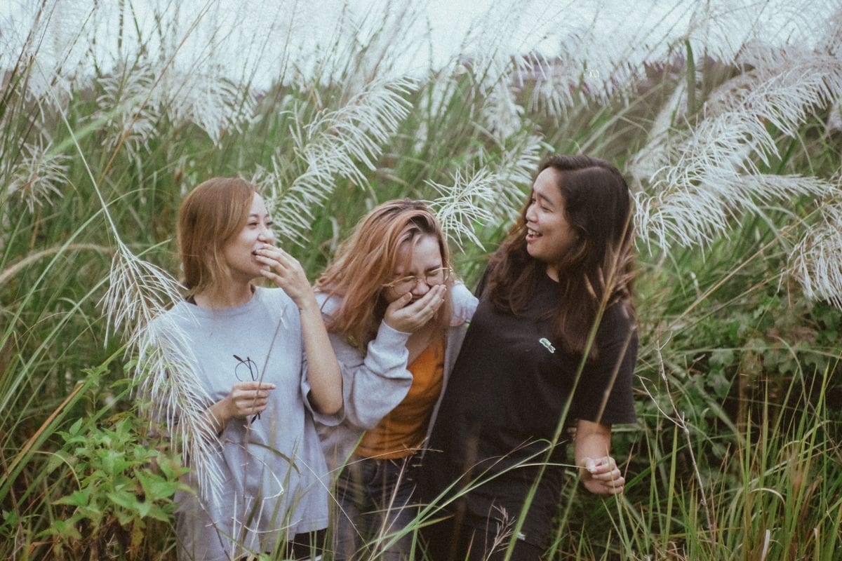 Friends laughing together outdoors, joy over data in 2026 wellness