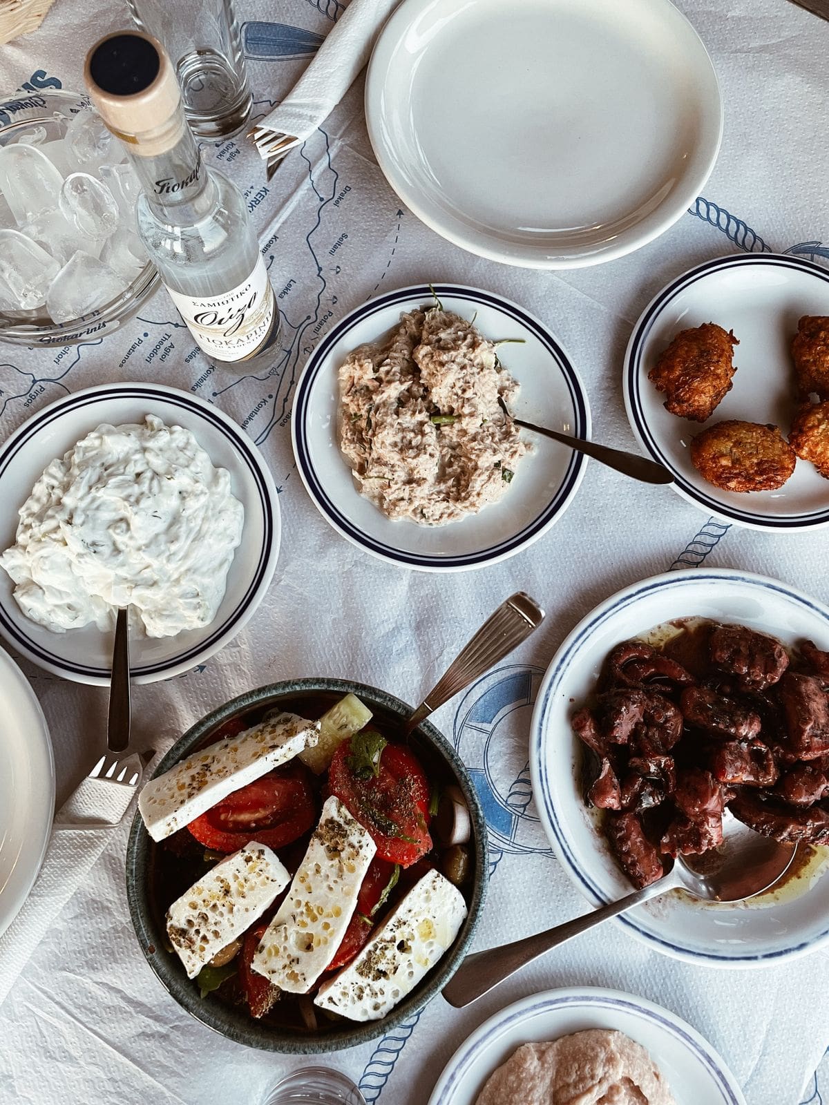 Greek Blue Zone style table with olive oil, greens, and mezze