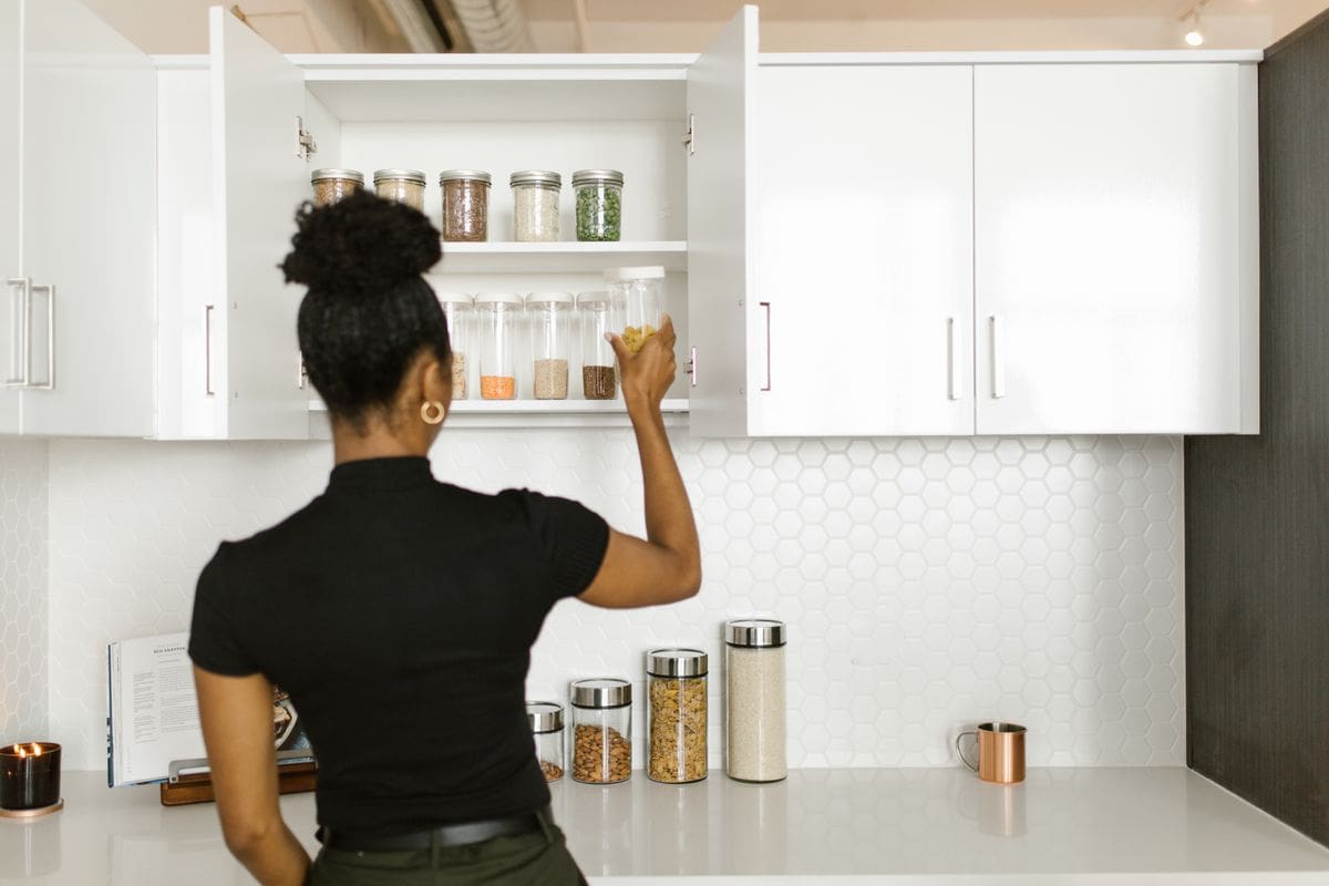 Organized pantry shelves in a calm, prepared wellness home