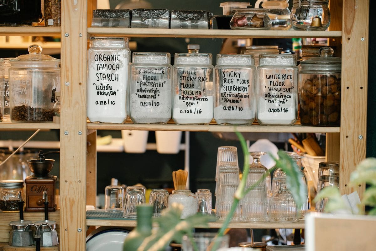 Neatly stocked pantry with labeled jars and staples